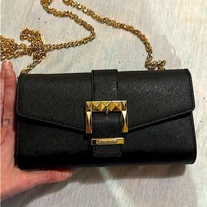 Sexy and small but comes with a big punch of fashion Michael Kors clutch purse!